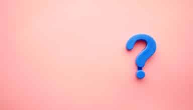 a blue question mark on a pink background