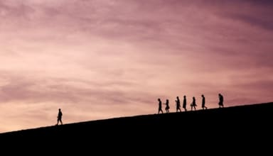silhouette of people on hill