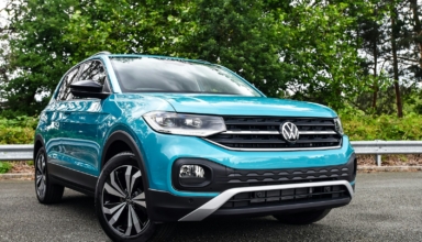 a blue volkswagen suv parked in a parking lot