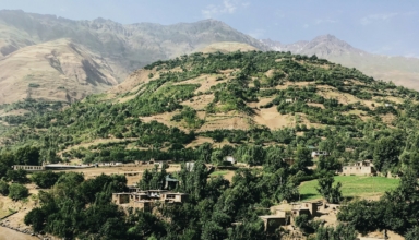 a hill with a village on top of it