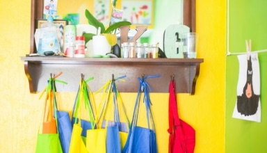 assorted-color bag lot hanging on brown wooden wall rack