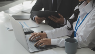 group of confident business people point to graphs and charts to
