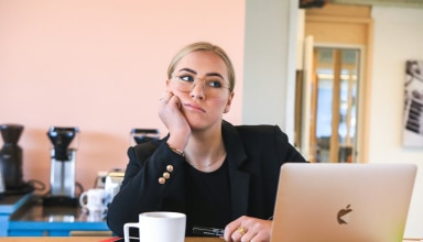 woman in black long sleeve shirt using macbook
