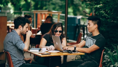 photo of three person sitting and talking