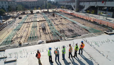 seven construction workers standing on white field