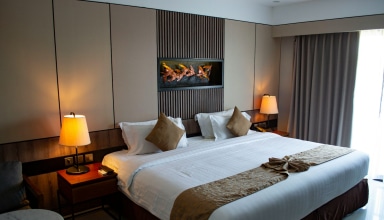 white bed linen with throw pillows